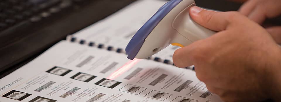 A hand uses a scanner for a barcode in a ProVisions branded portfolio.