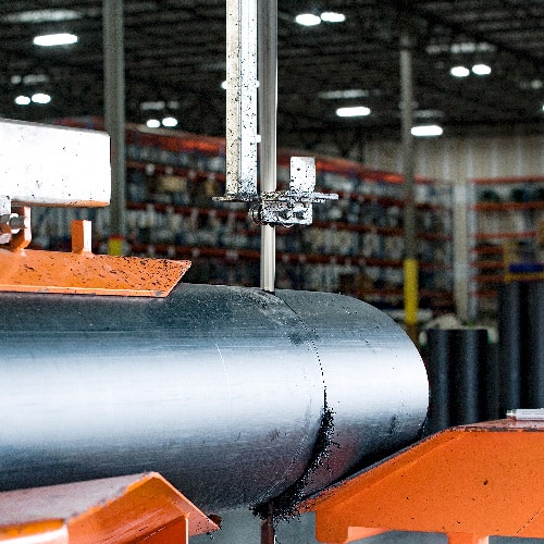 A large pipe is cut at a Ferguson pipe fabrication facility.