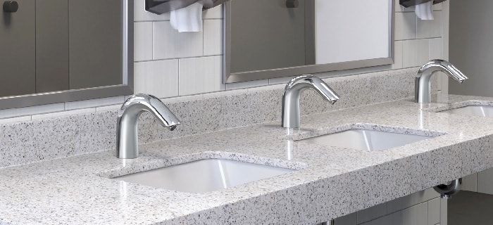 a row of sinks with touchless faucets in a bathroom